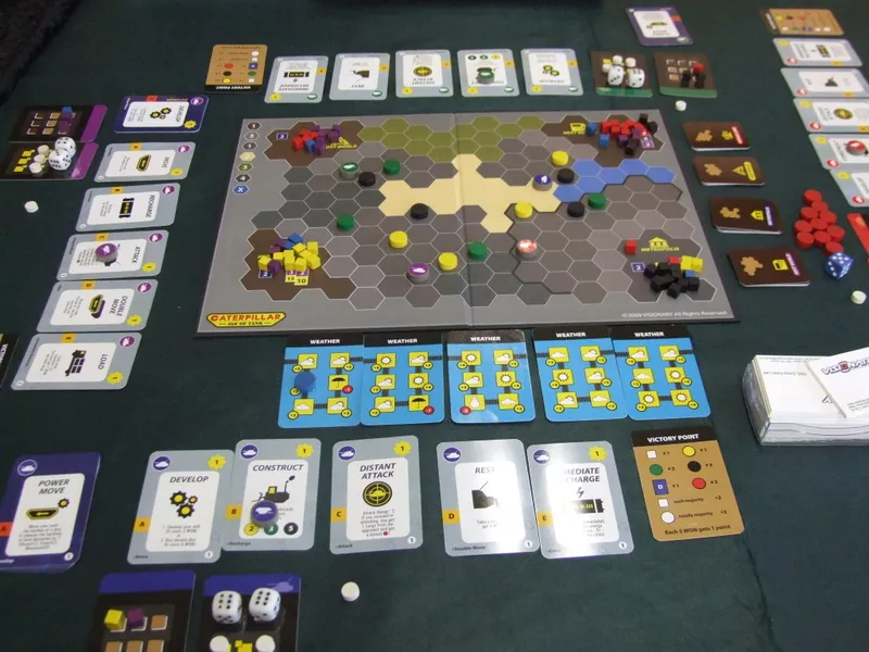 Caterpillar tower board game components including tank miniatures and resource tokens